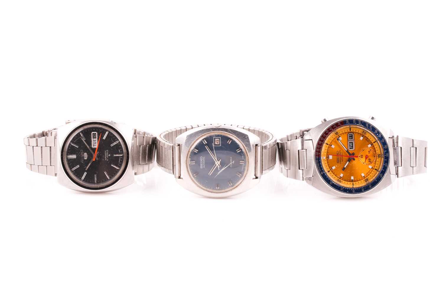 A group of three Seiko automatic stainless steel wristwatches.