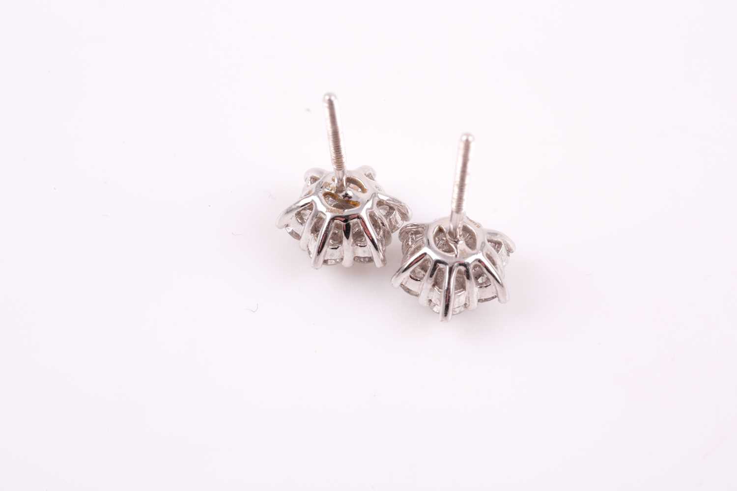 A pair of 18ct white gold and diamond stud earrings, each floral cluster set with round brilliant- - Image 2 of 3