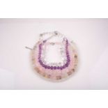 A chunky rose quartz beaded necklace, together with a faceted moonstone beaded necklace, a clear