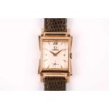 Omega. A rectangular gold cased 1940's wristwatch, the signed silvered dial with applied gilt dart