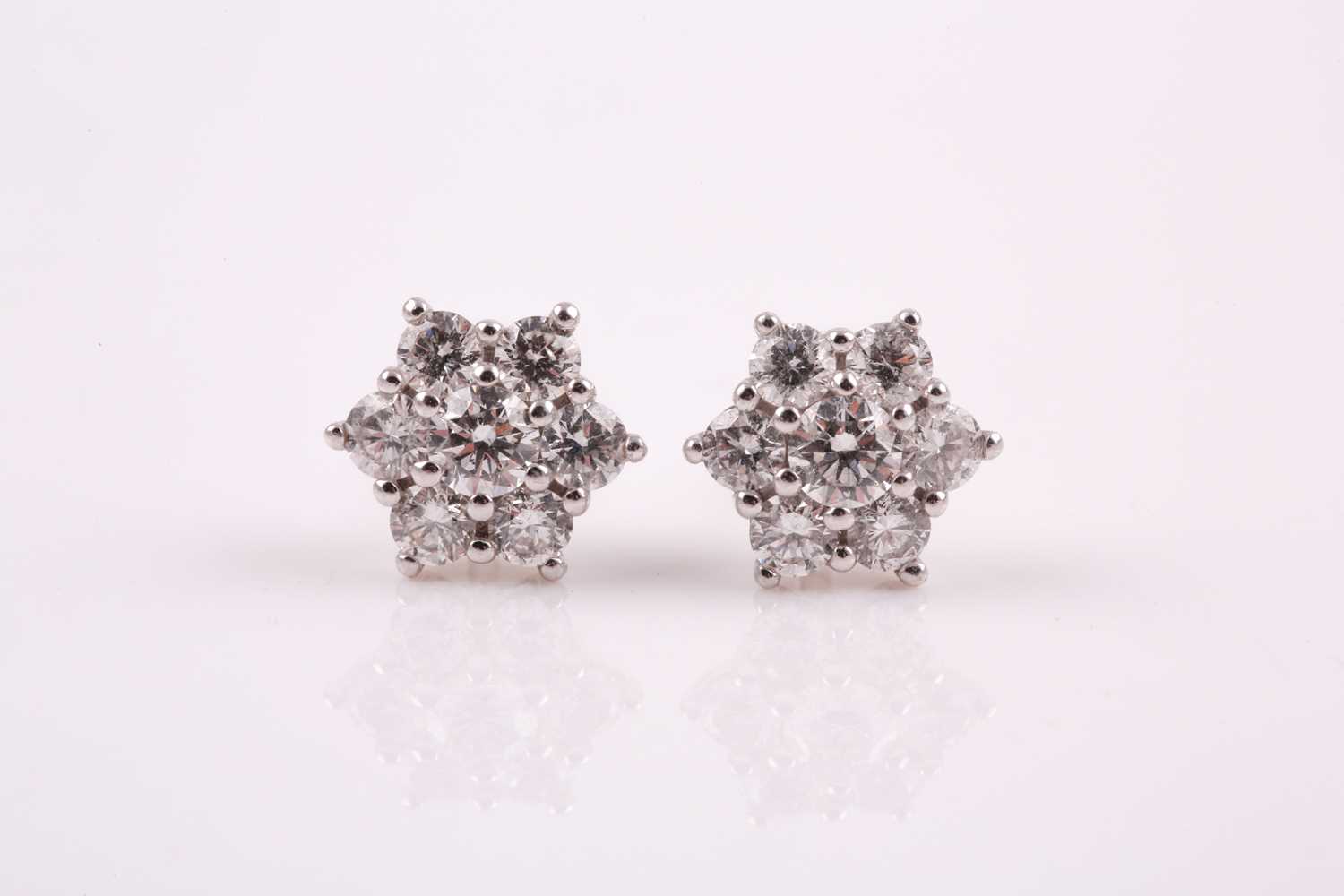 A pair of 18ct white gold and diamond stud earrings, each floral cluster set with round brilliant-