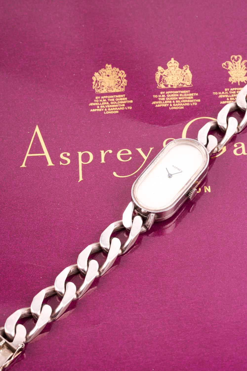 Asprey. A lady's silver wristwatch, the elongated oval brushed silvered dial with simple arrowhead - Image 6 of 18