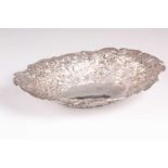 A Victorian silver sweet meat basket. London 1898 by William Comyns, shaped oval chased and engraved