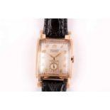 Gruen. A gentleman's gold curvex wristwatch, the champagne dial with Arabic numerals and