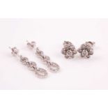 A pair of 9ct white gold and diamond floral cluster earrings, rubover set with round brilliant-cut