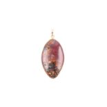 An 18ct yellow gold mounted boulder opal pendant, set with an elongated oval boulder opalm showing