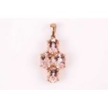 A 9ct yellow gold and morganite pendant, set with four mixed oval-cut morganites, pendant