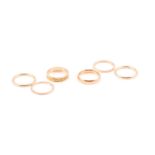 A group of gold rings, including a set of four plain yellow metal bands, size P, a 22ct yellow