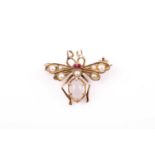 A gilt metal, moonstone, and pearl insect brooch, the wings set with pearls, small ruby eyes, and