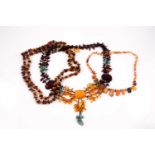 An opera-length multi-coloured amber necklace, together with a naturalistic amber beaded necklace,
