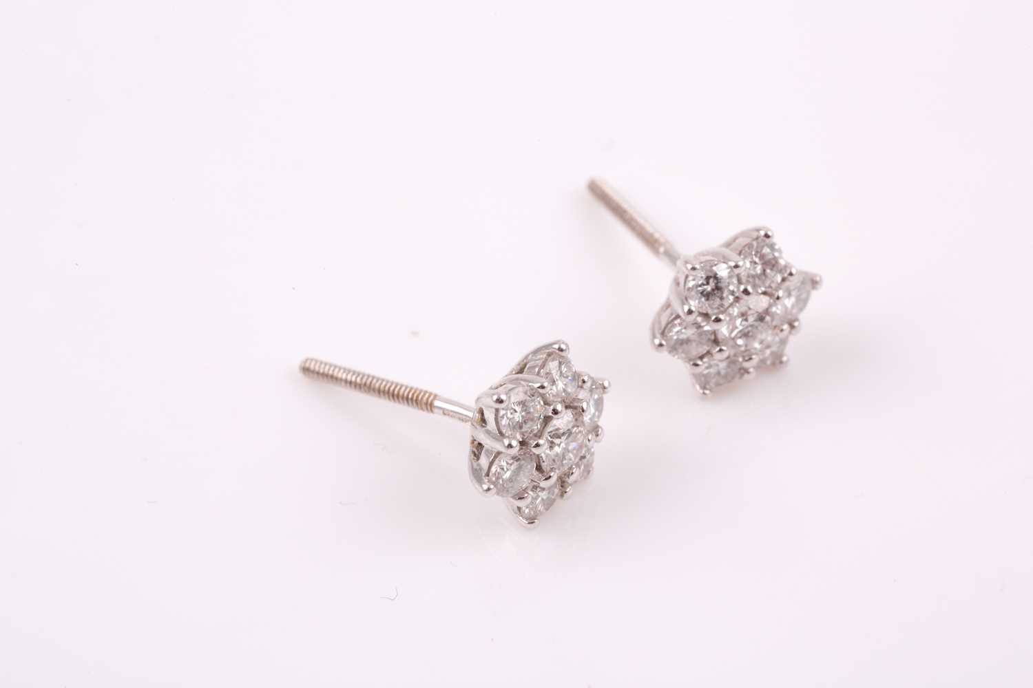 A pair of 18ct white gold and diamond stud earrings, each floral cluster set with round brilliant- - Image 3 of 3