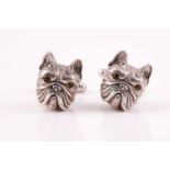A pair of white metal cufflinks each in the form of a French bull dog's with green gem-set collar,