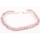 A pearl necklace, set with freshwater pinkish lilac pearls, of irregular naturalistic effect, with