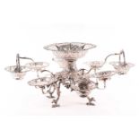 An Irish George III silver epergne, the central pierced and cast bowl engraved with a coat of