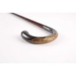 A 19th-century iron handled walking cane with snakewood walking cane. The handle with damascened