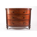 A Regency figured mahogany break bow-fronted commode chest of three long drawers. The drawers