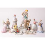 A Dulevo Soviet Russian porcelain figure group of a mother washing her children with a watering can.