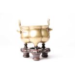 A Chinese brass censer, late Qing, of hexagonal lobed form, with simulated bamboo handles