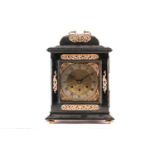 A German Musterschutz 'McCabe London' ebonised triple train table clock, with pull repeat in the