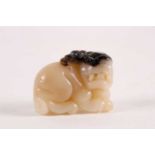 A Chinese, carved off-white and grey jade, Tang-style crouching lion. 81 grams 5 cm long x 3.8 cm