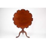 A George III mahogany 'Monteith' topped snap-top tripod wine table, with moulded edge above an urn