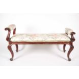 A mid-Victorian carved mahogany duet stool, with scroll ends and stuff over upholstery, supported by