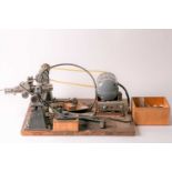 A vintage "Pultra" 18" watchmaker/model makers lathe with belt-driven power source and some tooling.