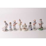 A Lomonosov Soviet Russian porcelain figure of a sailor boy with an accordion together with two