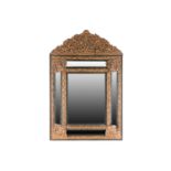 A large 19th century Italian pressed brass cushion moulded wall mirror, with ornated figural and