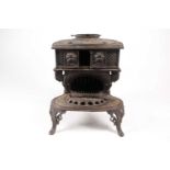 A Victorian "The Queen" model No5 small cast iron stove. With two hobs and an oval (5 3/4 flue)