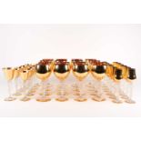 A suite of French Bayel Bacchante Crystal glasses, each with gilt bowl and opalescent glass stem