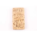 A mid 19th century Cantonese carved ivory card case, profusely chased with scenes from domestic