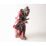 A Shiwan flambe glaze figure of Guandi, mid 20th century, a fierce expression upon his face,