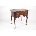 An early 18th-century oak kneehole lowboy with a thin thumb moulded top. Fitted one long frieze