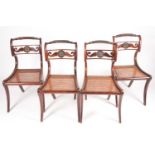 A set of four Regency simulated rosewood side chairs with knurled top rail and a gilt floral boss