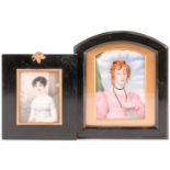 A Regency period portrait miniature of ivory of a young female, in empire line dress holding a book,