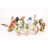 A group of polychrome enamel decorated porcelain birds, to include six yellow songbirds (some with