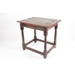 A late 17th-century oak single drawer side table. With planked top. On turned spindle supports