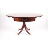 A George III ebony and satinwood strung mahogany oval dropleaf table. With sabre legged