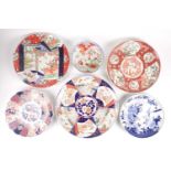 A group of Japanese Imari & Kutani chargers, Meiji period, comprising a large charger, painted