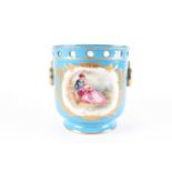 A French jardiniere with a hand-painted reserve depicting a romanticism scene, floral spray to the