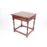 A late 18th-century oak side table. With turned spindle supports united by a box stretcher. 59.5