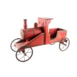 A vintage, presumably American folk art, crimson painted wood, pull along steam engine with spoked