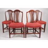 A set of eight George III "Hepplewhite" style camelback, mahogany dining chairs with bullrush splats