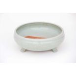 A Chinese celadon bowl, 14th/15th century, with incurved rim above a body engraved with flowers
