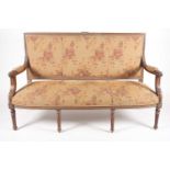 An early 20th century, French Louis XVI style carved beechwood three seat sofa. With floral stuff