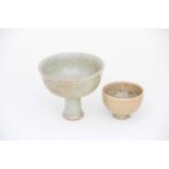 A Chinese Guan stem cup, the pale grey/green glaze suffused with brown crackle,13cm diameter; and