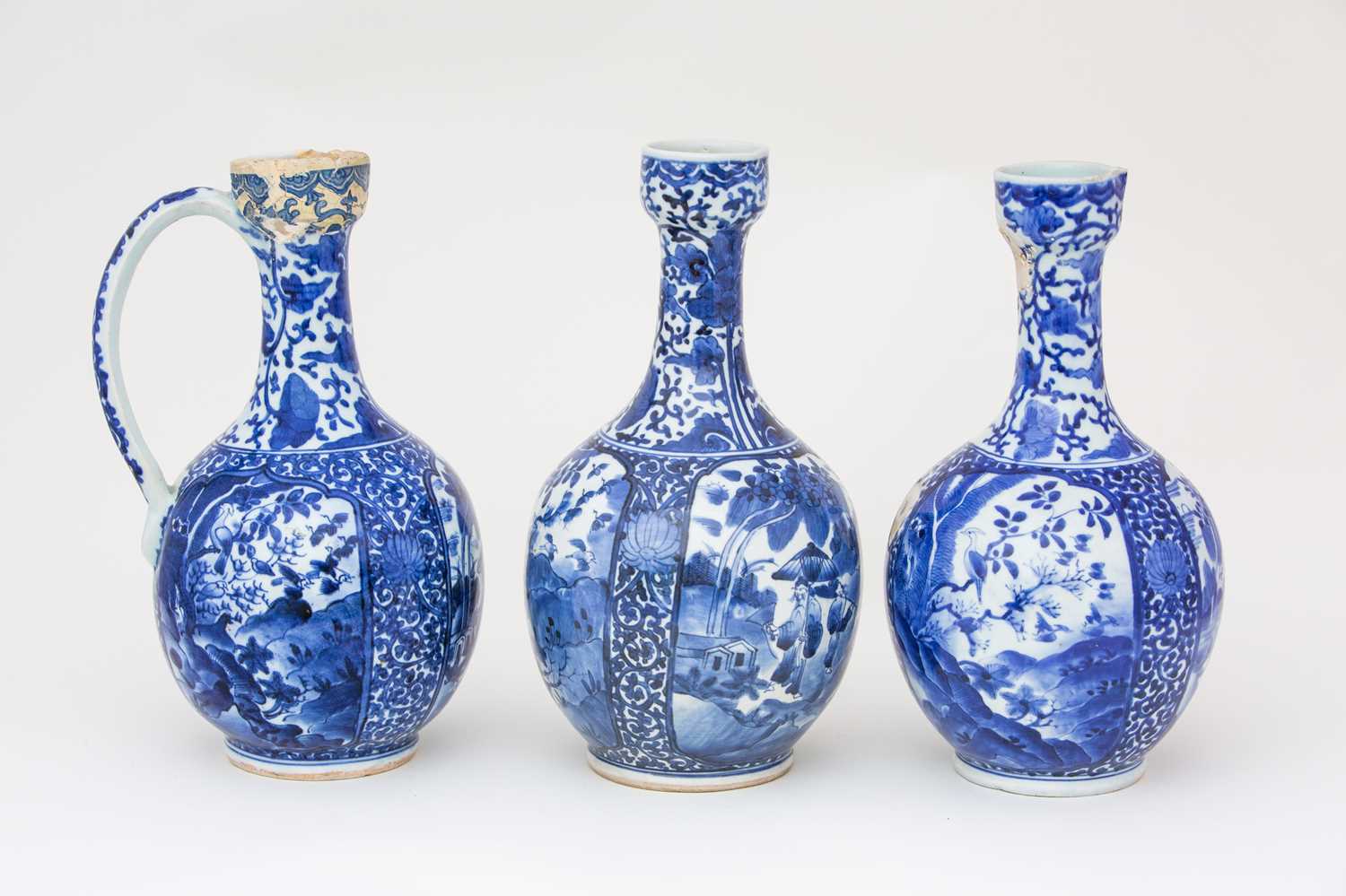 Three Japanese blue & white ewers, circa 1670 -1690, each with oviform body, with cup shape mouth