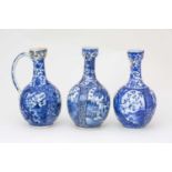 Three Japanese blue & white ewers, circa 1670 -1690, each with oviform body, with cup shape mouth