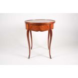 † A Louis XV style, circular mahogany, and tulipwood veneered centre table. The tray top with